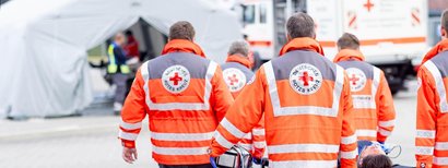 Several paramedics are carrying a patient together