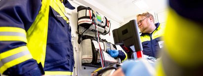 Two paramedics are treating a patient in the ambulance