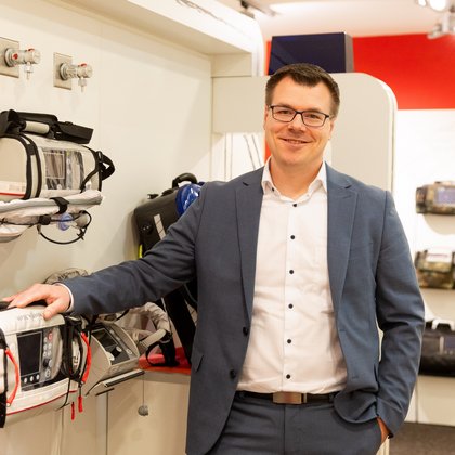 Ole Tobian places one hand on a WEINMANN medical device